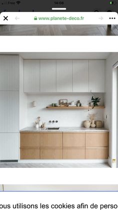 a kitchen with wooden cabinets and white counter tops, along with shelves above the sink