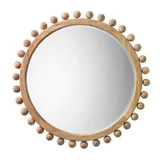 a round mirror with wooden balls around it