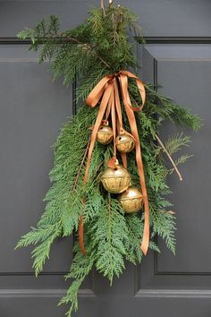 a christmas wreath with bells hanging from it's side on a door, and the words instagram written below