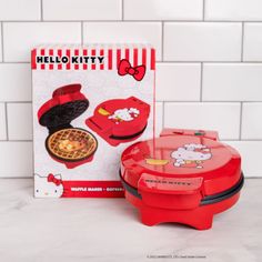 the hello kitty waffle maker is next to its box