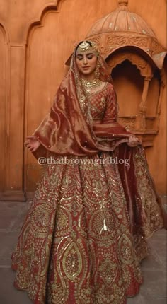 a woman in a red and gold bridal gown