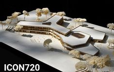 an architectural model of a building with trees and snow on the ground in front of it