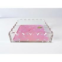 a pink and clear glass tray with hearts on the bottom, sitting on a white surface