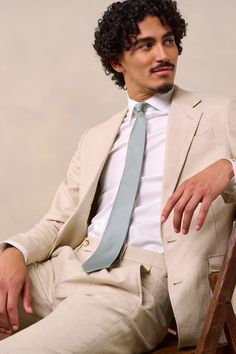 The perfect suit for summer wedding - Tan, linen suit for summer 

Crafted from a tan linen and cotton fabric with an unlined jacket to keep things breezy. 

53% Linen, 47% Cotton
Unlined
Patch pockets with flap
Two-button closure
Notch lapels
Side vents
Single pleated pants
Belt loops Tailored Beige Suit For Spring, Tailored Beige Spring Suit, Timeless Beige Linen Suit, Spring Beige Tailored Suit, Beige Semi-formal Spring Suits, Tailored Summer Suits For Business Casual, Summer Business Suits With Suit Collar, Tailored Summer Business Casual Suits, Summer Tailored Business Casual Suits