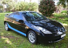 a black sports car parked in the grass