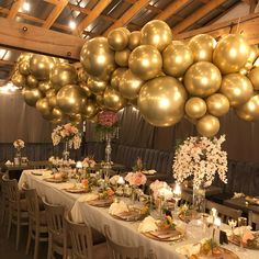 a long table is set with gold balloons