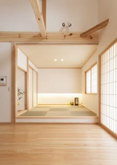 an empty room with wooden floors and white walls