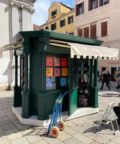 an outdoor kiosk on the side of a street