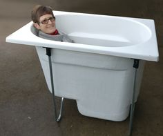 a young boy is sitting in a bathtub