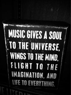 a sign that says music gives a soul to the universe, wings to the mind, flight to the imagination, and life to everything