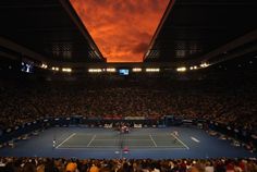 a tennis match is being played in an arena