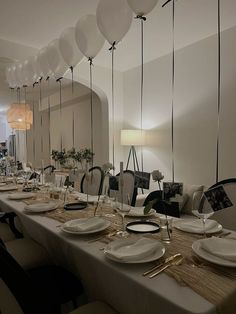 a long table is set with plates and silverware for an elegant dinner or party