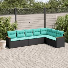 an outdoor sectional couch with blue cushions