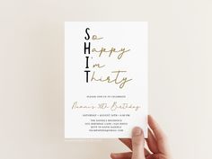 someone holding up a card with the words so happy on it in gold foil lettering