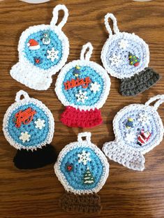 six crocheted christmas ornaments on a table