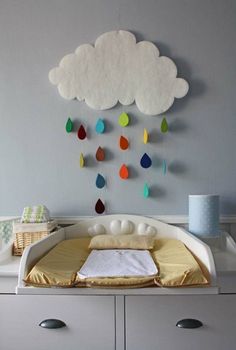 there is a cloud with rain drops hanging on the wall