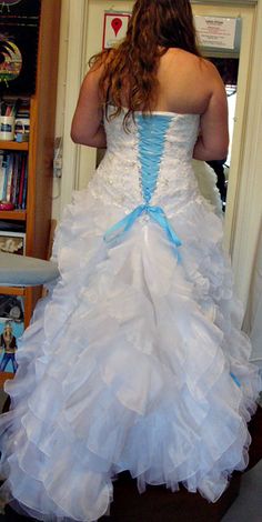 a woman in a white and blue wedding dress