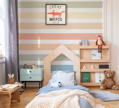 a child's bedroom with striped wallpaper and wooden bed frame, teddy bear on the floor