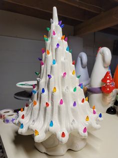 a white ceramic christmas tree sitting on top of a counter