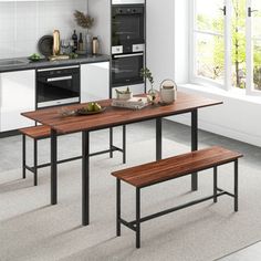 a kitchen table with two benches next to it and an oven in the back ground