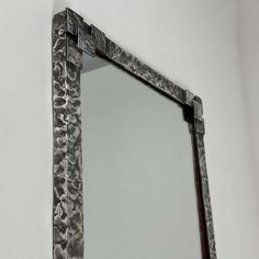 an ornate mirror is hanging on the wall