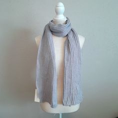 a gray knitted scarf on a mannequin