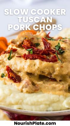 slow cooker tuscann pork chops on top of mashed potatoes