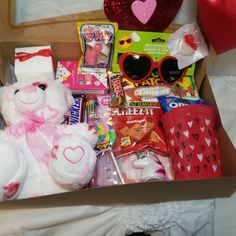 a box filled with lots of candy and stuffed animals