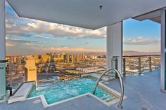 an outdoor hot tub overlooking the city skyline