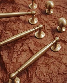 brass handles and knobs on brown paper