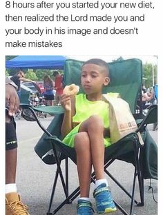 a little boy sitting in a chair eating something