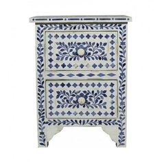 a blue and white cabinet with two drawers on the bottom, one drawer has an ornate design