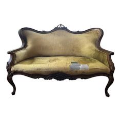 an antique style couch with gold upholstered fabric