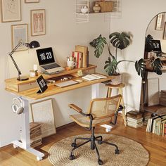 a desk with a laptop on it in front of a mirror and bookshelf