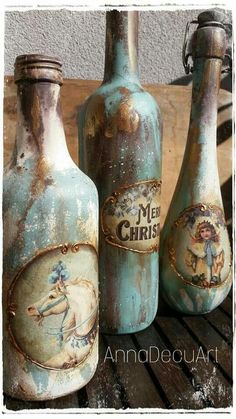 three old blue bottles are sitting on a wooden table and one is painted with an image of a man riding a horse