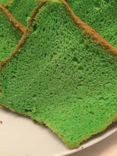 three pieces of green cake sitting on top of a white plate