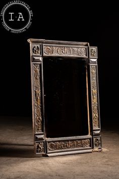 an ornate mirror is shown against a black background