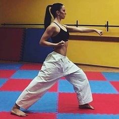 a woman standing on one leg in a yoga pose