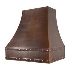 a large copper colored stove hood with rivets on the sides and an exposed vent