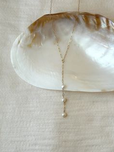 "This gorgeous Pearl lariat necklace is made with the prettiest high quality off-round  freshwater pearls. The 14K Gold Filled or 925 Sterling Silver paperclip chain is dainty yet strong. This is a gorgeous necklace to wear for special occasions or everyday! The necklace is adjustable and can be worn at choker length up to 18 inches. * Choose from 14K Gold Filled or 925 Sterling Silver 2.5x5mm dainty paperclip chain * Quality lobster clasp closure * 15\" with 2\" extender chain (adjustable 15\"- Pearl Drop Necklace Wedding, Drop Necklace Wedding, Bridal Events, Pearl Lariat Necklace, Pearl Lariat, Wire Wrapped Jewelry Diy, Pearl Drop Necklace, Silver Collection, Y Necklace