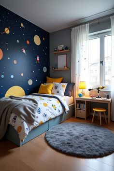 a child's bedroom decorated in blue and yellow with space themed wallpapers