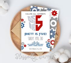 a white and red party card with the number five on it next to cotton balls