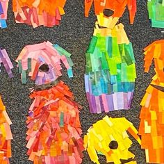 several pieces of colored paper cut out to look like dogs and cats with their faces made from them