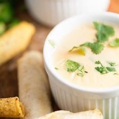 there is a bowl of soup and crackers on the table