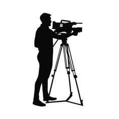 a man standing next to a camera on a tripod