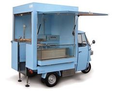 an ice cream cart with wheels on the front and side is shown in light blue