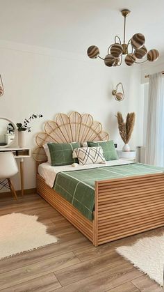 a bedroom with white walls and wood flooring has a large bed in the center