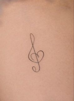 a musical note tattoo on the back of a woman's stomach