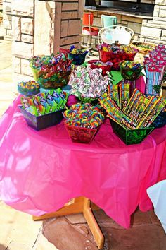 a table topped with lots of cupcakes and candy