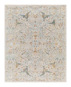 an area rug with various colors and designs on the floor, including blue, beige, orange